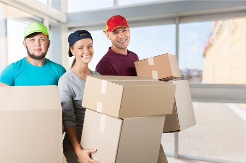 Local movers transporting boxes in a South London street
