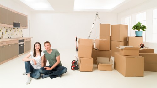Unpacking boxes in a Lambeth flat after relocation